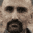 A pixelated image of a man's face with a beard and mustache, followed by a sequence of yellow chevron arrows and text reading "DEATH RACE" on a black background.