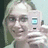 A pixelated image of a person holding a camera, with text overlays on colored backgrounds.