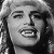Black-and-white pixelated image of a person with light hair, closed eyes, and an open mouth showing teeth, wearing a dark top.