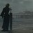Silhouette of a figure in long dark clothing holding a vertical object against a muted gray background.