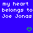 Blue background with repeated white text 'my heart belongs to Joe Jonas' and green pixelated hearts in a pattern