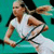 Pixelated image of a person in a white sleeveless top holding a tennis racket, set against a teal background.