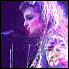 A six- shows a person with blonde hair in various poses and lighting conditions, including stage performance shots with microphones