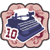 Pixelated icon with rounded corners showing a blue and white object resembling a ship or submarine on a light pink background with red decorative elements.