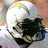 A pixelated image shows a character with white hair and yellow accents on the left, next to blue background text reading "TOMLINSON 21" in yellow.