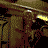 Animated sequence showing a pixelated character with glowing yellow eyes and brown hair, transitioning to a blue 'DOOM' logo on black background.