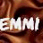 A static image of the text "EMMI EMMI" in large white block letters over a brown fabric background with visible folds and shadows.