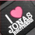 A black square icon with a pink heart symbol and white text reading "I ❤️ JONAS" in pixelated font, featuring subtle animation changes across frames.