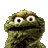 Pixelated green muppet-like character with large white eyes, black pupils, and a wide black mouth against a solid gray background.