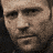 A pixelated animated icon featuring a man's face transitioning to a yellow chevron pattern with 'DEATH RACE' text.