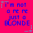 A bright pink background displays six identical of blue pixelated text reading "i'm not a re re just a BLONDE" with small cyan and gray star-like dots around the edges