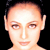 Static pixelated image of a person's face with smooth skin, visible facial features including eyes, nose, and mouth against a black background.