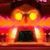 A pixelated cartoon face with glowing yellow eyes, a wide red mouth showing two large white teeth, and an orange-yellow gradient background.
