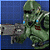Pixelated green armored figure with blue eyes and red mouth detail stands against blue background holding gray object.