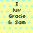 Yellow background with light blue star pattern, repeated text "I luv Gracie & Sam" in black pixelated font across multiple
