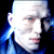 Static pixelated image of a person's face in profile with blue and white tones against black background, likely from a movie or character reference.