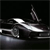 Pixelated grayscale image of a sleek vehicle with a prominent front grille and angular headlights, set against a dark background.