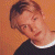 A split-frame contact sheet showing a pixelated portrait on the left and green text logo on the right against an orange background.