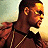 Pixelated buddy icon featuring a man in profile on left and green text logo on right, split-screen style with warm background gradient.