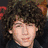 Three distinct views of a person with curly brown hair in different settings and expressions.