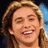 A pixelated image of a person with light brown hair smiling, split into two side-by-side showing text overlay changes