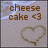 Pixelated image with brown text reading 'cheese cake <3' above a heart-shaped object on a light gray background.