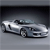 Pixelated silver convertible car with dark interior, angled view on gradient gray background, no visible text or additional elements.