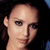 Pixelated close-up of a person's head and neck against dark background with blue accents.
