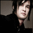 A pixelated image of a person with dark hair and a black top against a dark background, with text on a maroon field reading "Makes the whole world go round..." and "Just a spoon full of Jimmy... R.I.P. Jimmy 2/10/81-12/28/09".