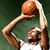 A basketball player in a white jersey with green accents is shown in three sequential poses: holding a ball above the head, shooting, and celebrating.