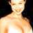 Static pixelated image of a person's upper body with closed eyes and smiling mouth against black background, rendered in warm tones.