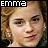 identical pixelated images showing a person with light brown curly hair, pink lips, and small earrings against a dark background