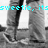 Black-and-white image of a person's lower body in jeans and sneakers with cyan text overlays, showing slight movement between frames.