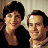 Static 48x48 pixel buddy icon showing two smiling people in close proximity against a light background with dark hair and black clothing on the left figure.