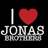 A black background displays three identical pixelated icons with 'I ❤️ JONAS BROTHERS' text, each featuring a red heart symbol replacing 'love' and white stylized lettering.