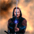 A figure with long dark hair holds a glowing blue object against a smoky orange background, with subtle variations in pose and background across frames.