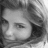 Grayscale pixelated image of a person's face with closed eyes, dark hair, and a neutral expression, cropped to show only the upper face and hair.