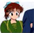Pixelated cartoon-style icon of a person with brown hair wearing a green hoodie, standing next to a dark blue object with a visible hand.