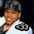 A pixelated image of a person wearing a dark cap and white shirt with <33 text, alongside bold text reading 'The Next Micheal Jackson' and 'What a Thriller!' on dark backgrounds.