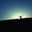 Pixelated static image of a dark silhouette against a gradient sky transitioning from deep blue to pale green with a bright light source near the horizon.
