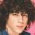 Pixelated image of a person with curly brown hair against a pink background, with text overlay reading "I'm Burning Up For You Baby..." in black and white block letters.