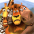 Pixelated static image of three cartoon animal characters from Madagascar Escape 2 Africa, featuring a giraffe, zebra, and hippo in close-up with expressive faces against a blue sky background.