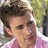 A pixelated image shows a person with short brown hair wearing a pink shirt, next to cyan text on black background reading 'chris evans is an old ugly man'.