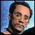 Pixelated static image of a person with dark hair and light skin against a blue gradient background, rendered in low-resolution 256x256 pixels.
