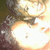 A pixelated image of a person's face with bright lighting, showing two distinct views where the right eye is visible in one view and not present in another.
