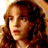 Pixelated static image of a person with long brown hair and light skin tone, cropped to show upper body against warm-toned background.