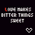 five and five displays pixelated text 'LOVE MAKES BITTER THINGS SWEET' with rainbow-colored letters, white hearts below each phrase, and animated heart icons at the bottom
