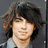 A pixelated image of a person with long dark hair in two poses, one front-facing and one side profile, with a purple and pink abstract background.