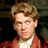 Static 48x48 pixel buddy icon showing a person with light brown hair wearing a red jacket over a white shirt against a dark background.