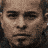 A pixelated image shows a person's face with a goatee, transitioning into a fragmented, particle-like effect, followed by yellow chevron arrows and text reading "DEATH RACE" on a black background.